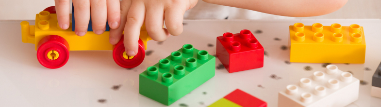young children playing with colourful lego